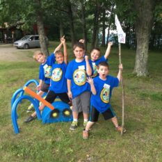 Cub Scouts with flags at Camp