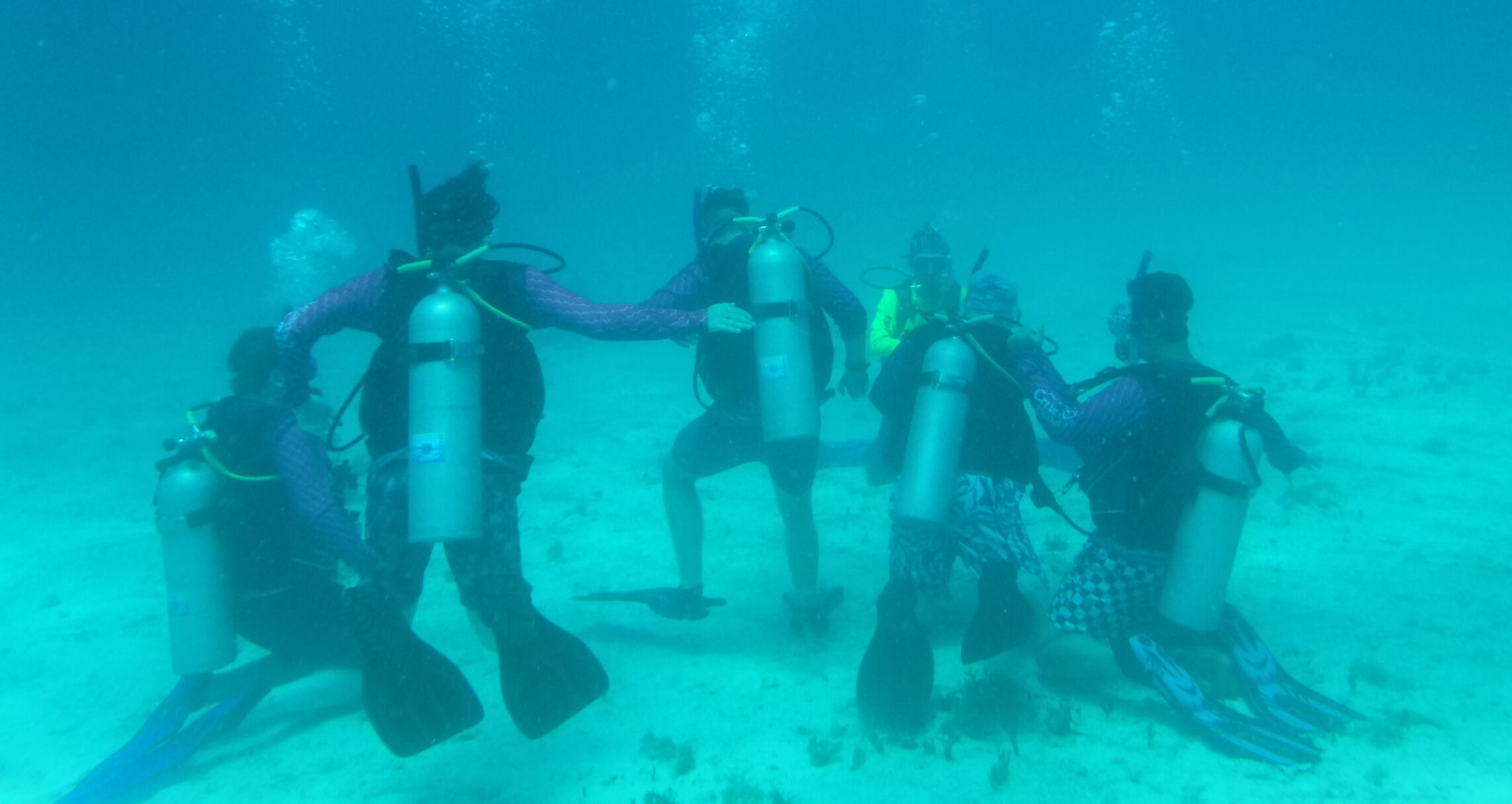 Venturing Crew 4020 in full Scuba gear making a ring underwater at Sea Base in Florida