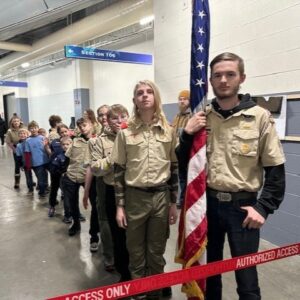 Scouting America Troop 50 and other Scouts lined up to present the America flag before a hockey game